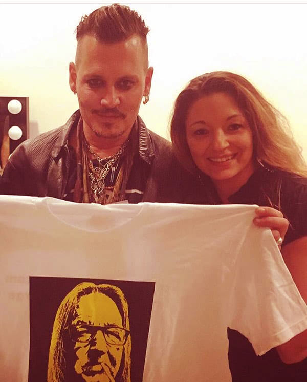 Image of Caption: Kristina Sunshine and Johnny Depp, a clothing line branded "Boston George Apparel and Merchandise"