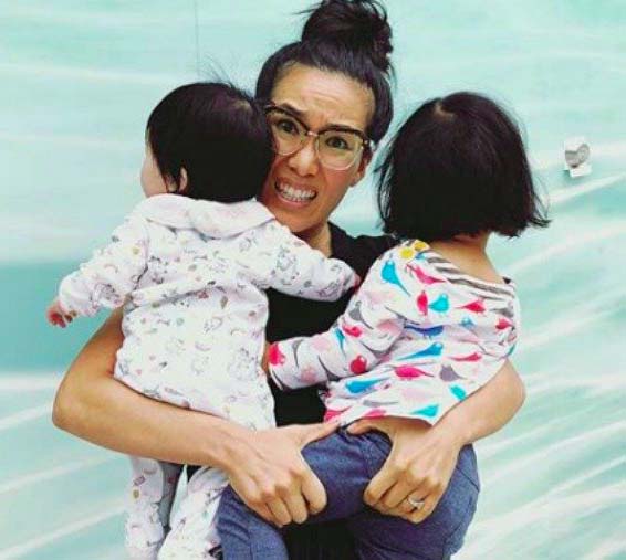 Photo of Ali Wong caring her children.