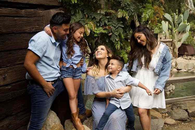 Rosie Rivera looking happy with her husband, and children
