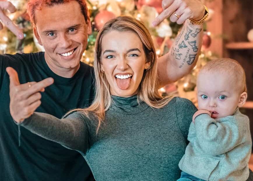Image of Brittney Noell with her husband, Logic, and their baby